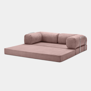 Primyhome pink convertible sleeper sofa bed in unfolded position, showcasing the corduroy fabric and metal side rails